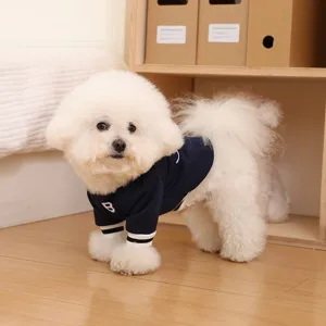 Detailed view of a cute pet wearing a navy blue warm winter dog hoodie with embroidery.
