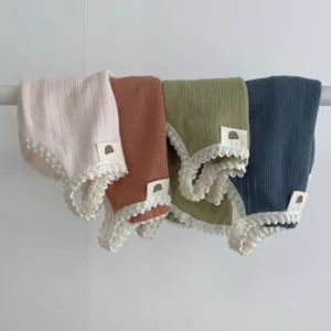 Detailed view of breathable lace-trim pet sling vests in four colors, soft knit fabric.