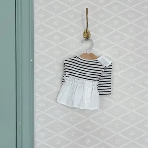 Detailed view of the cute pet striped dress, featuring a black-white top and white ruffled skirt.