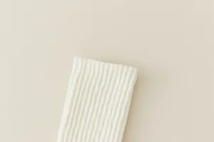 White knit knee high socks detail close up shot showing the soft ribbed texture clearly.