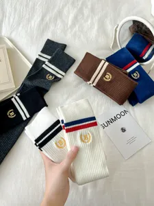 JK style collegiate over-the-knee long socks featuring double stripes and embroidery.