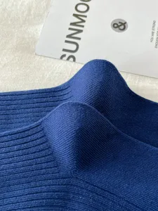 Close-up detail of dark blue ribbed knit over-knee JK socks, showing fine texture and soft fabric.