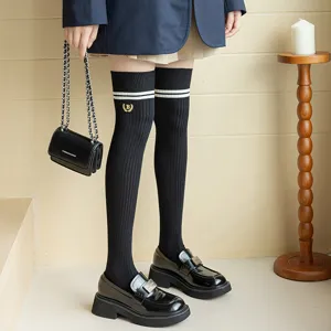 Classic black over-the-knee JK socks featuring double white stripes and elegant gold embroidery.