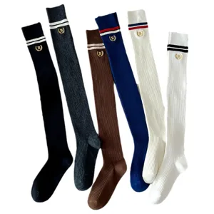 Japanese preppy style ribbed knit knee high socks with cute embroidery and striped cuffs.