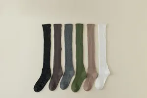 Detail shot of ribbed knit over-the-knee slouch socks with metallic thread, soft cozy texture.
