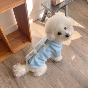 Detail view of cute autumn winter pet dog sweatshirt in light blue with sweet white bow decor.
