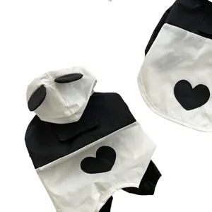 Black and white pet raincoat with cute panda ears and heart patch, perfect for small dogs daily wear.