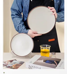 Detailed shot of ceramic dinner plate with stylish brown rim, perfect for home dining.