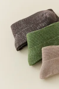 Close-up detail of women glitter ribbed knit socks showing metallic thread texture and colors.