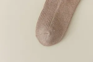Detail shot of glitter knit sock toe, showcasing metallic thread and vertical ribbed texture.