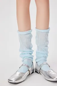 Close-up detail of light blue slouch socks paired with silver shoes, sweet ballet style design.