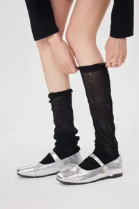Detail shot of sheer black leg warmers styled with silver shoes for a sweet ballet aesthetic.