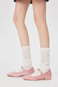 Detailed view of women's white sheer slouch socks paired with pink Mary Jane flat shoes.