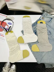 Thin breathable stirrup leg warmers detail view, mesh knit summer socks in white and grey colors.