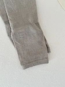 Women's knit socks detail view, featuring fine ribbed texture and solid color design.