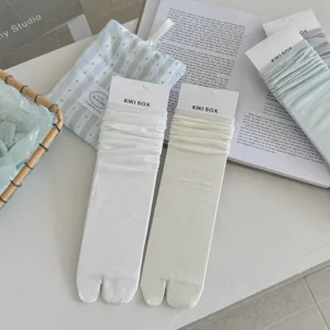 Detailed view of women's breathable solid color cotton split-toe tabi long socks.