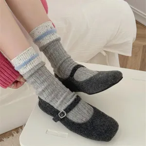 Detailed shot of cozy flecked cable knit slouch socks, soft warm mid-calf design style.
