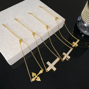 Variety of gold-plated stainless steel cross bracelets with sparkling zirconia stones.