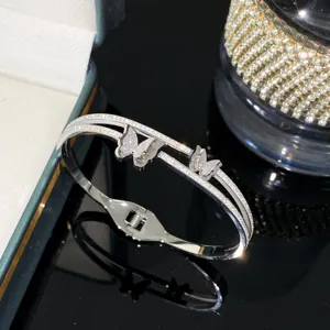 Close-up of double-layer titanium steel bangle with sparkling butterfly motifs