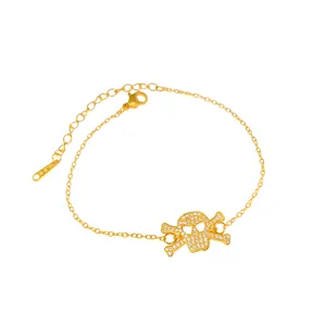 Gold titanium steel bracelet featuring a crystal-encrusted skull charm on white background.