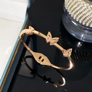 Rose gold titanium steel butterfly bangle with frosted cut-out design details