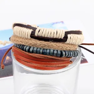 Close-up detail of multi-layer leather and wooden bead braided bracelet set with boho style.