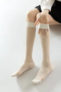 Sheer white knee-high socks featuring delicate heart and diamond knit patterns, breathable and soft.