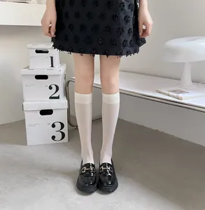 Detailed view of ultra-thin sheer white calf socks, breathable mesh knee high hosiery.