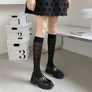 Detailed close-up of women's black sheer knee-high socks featuring stylish diamond mesh pattern.