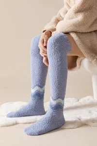 Cozy over-the-knee coral fleece socks detail shot, soft plush warm winter home wear lifestyle