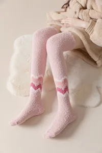 Cozy pink fuzzy over-the-knee socks for women, thick plush winter long warm stockings.