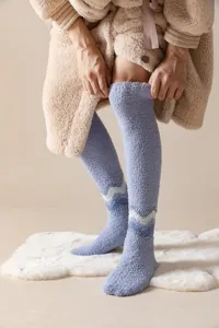 Soft fuzzy over-the-knee winter thermal sleep socks detail view, cozy coral fleece texture.