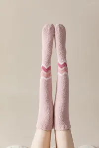 Close-up of thick coral fleece over-the-knee socks showing soft plush texture and chevron pattern.