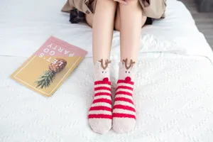 Cozy coral fleece Christmas socks for women, featuring cute 3D reindeer design and warm fit.