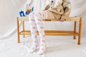 Cozy over-the-knee coral fleece socks for women, cute pink polka dots, warm winter sleep home wear.