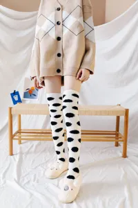 Cozy coral fleece over-the-knee socks with cute polka dot pattern for winter warm wear.