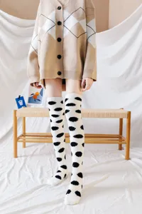 Knee-high coral fleece socks with cute polka dot pattern, cozy autumn winter sleep socks for women.