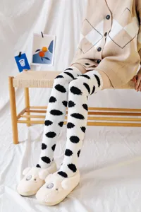Close-up detail of cozy fuzzy over-the-knee socks with cute black polka dots, soft texture.