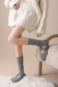 Grey knit stirrup socks paired with wool shoes for cozy autumn winter daily wear detail.