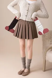 Ballet wool stirrup leg warmers detail view, soft knit slouchy socks in black and white.