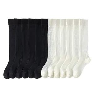 Women knee high long socks set in black and white with cute knit patterns for daily wear.