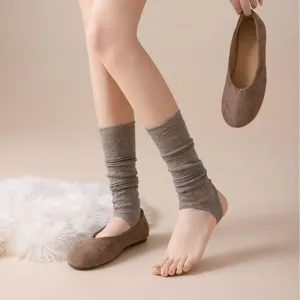 Knit stirrup leg warmers for women, cozy winter long socks with hollow-out patterns.