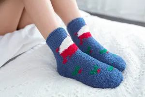 Close-up view of cozy coral fleece Christmas socks showcasing soft fuzzy texture and knit patterns.