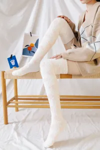 Cozy over-the-knee coral fleece socks for women, cute polka dot design for autumn and winter.