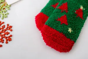 Cozy coral fleece Christmas socks with cute tree pattern for winter indoor warm wear detail.