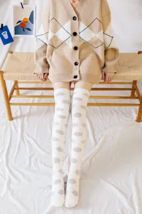 Cozy over-the-knee coral fleece socks with cute dot patterns, soft winter sleep hosiery.