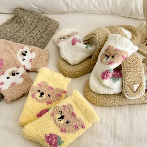 Cozy coral fleece fuzzy socks and slippers set with cute bear design for warm home wear.