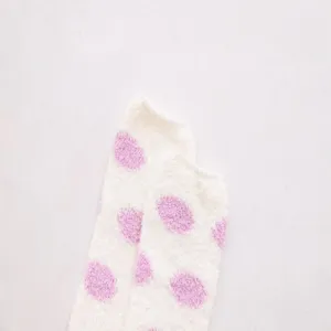 Cozy coral fleece over-knee sock detail showing soft white fabric with cute pink polka dots.
