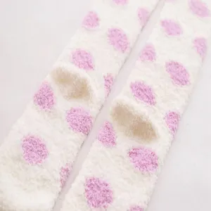 Cozy over-the-knee coral fleece women socks with cute pink polka dots detail shot.