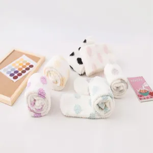 Detail view of Japanese cute polka dot coral fleece knee-high socks for women, soft home sleep.